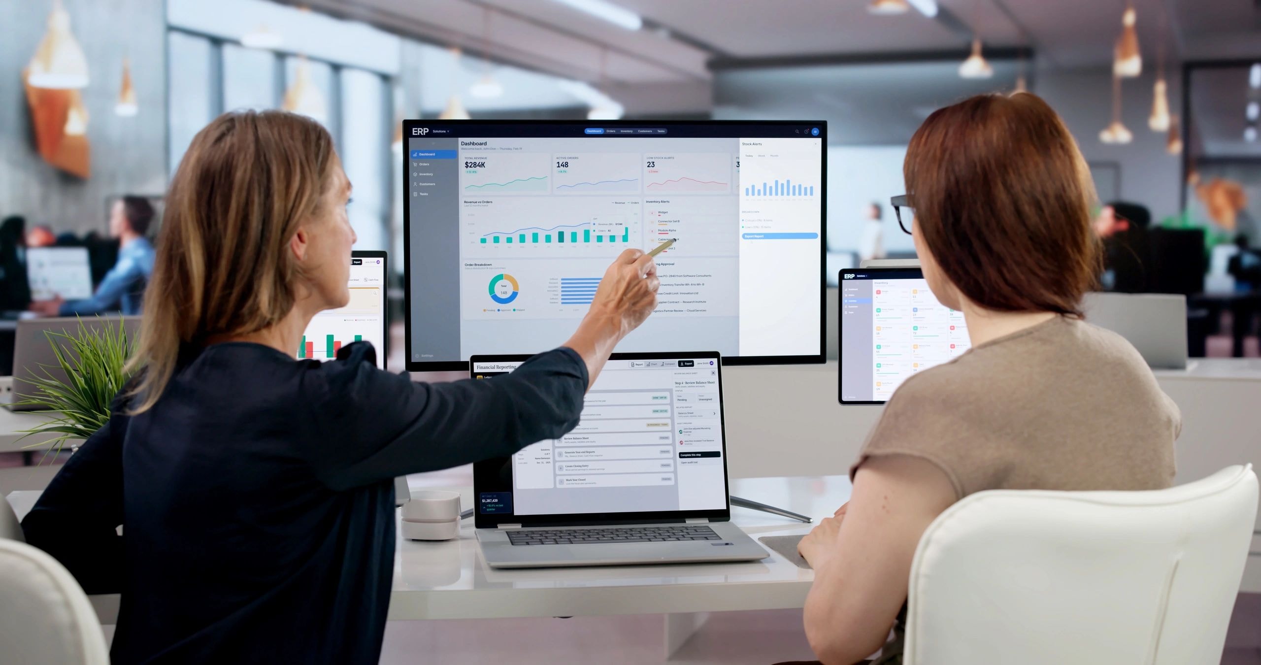 Women reviewing ERP dashboard in office